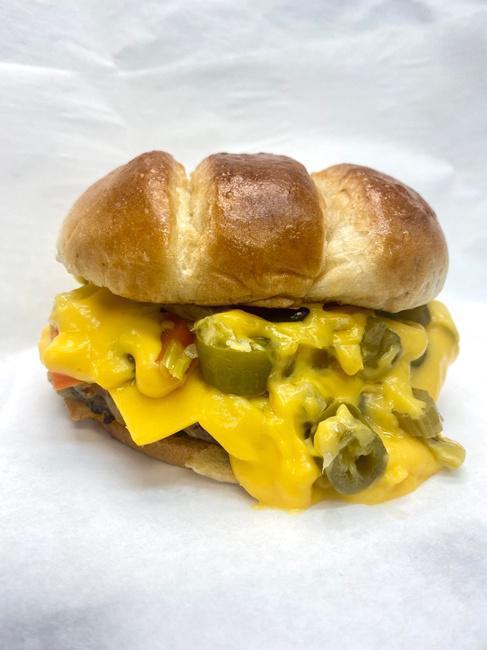 Melted Maniac Burger · Fresh, never frozen burgers! Hot Giardiniera and loads of Cheddar Cheese Sauce.