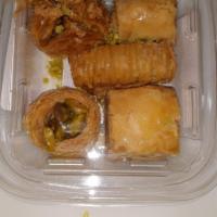 Baklava (5 Pieces) · A rich, sweet pastry with layers of filo dough filled with chopped nuts & sweetened with syr...