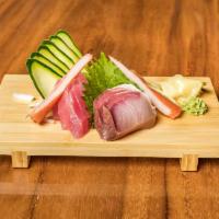 Sashimi Appetizer · 9 pieces. Tuna, king salmon, and yellow tail.