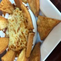 Spinach Artichoke Dip · Our house-made creamy spinach artichoke dip covered with mozzarella. Served with fried pita ...