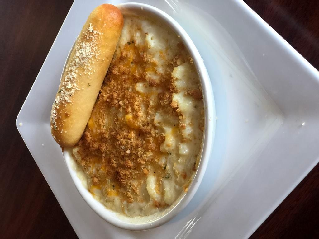 Three-Cheese Mac · Our 3-cheese blend tossed with elbow noodles and our signature Alfredo sauce. Oven-baked with a Parmesan bread crumb crust. Served with garlic toast. Add bacon or chicken for an additional charge.