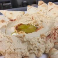 Hummus · House made blend of chickpea puree topped with extra virgin olive oil and Kalamata olives.