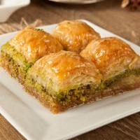 Baklava · Thin layers of phillo dough stuffed with ground pistachios, almonds and walnuts then glazed ...