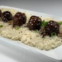 Teriyaki Meatballs · Hand Rolled Beef & Pork / Teriyaki Sauce / Scallions / Sesame Seeds 
Served with Wonton Stri...