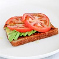 Avocado Toast · Whole grain toast, topped with sliced avocado, tomato, olive oil and salt.