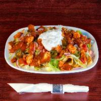 Spicy Chicken Nachos · Tortilla chips topped with queso blanco and cheddar Jack cheese, lettuce, tomatoes, red onio...
