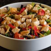Southwest Chicken Salad · Grilled chicken served over a blend of greens topped with cheddar Jack cheese, tomatoes, avo...