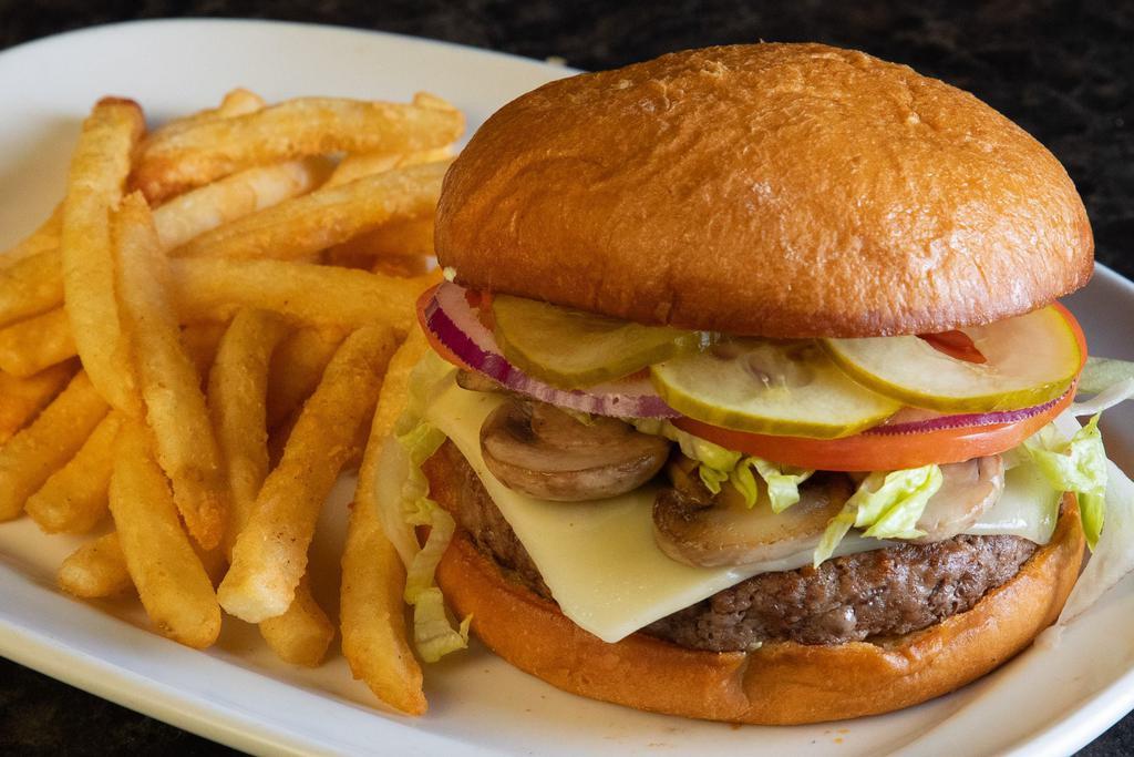 Mushroom Swiss Burger · Smothered with fresh, sauteed mushrooms and Swiss cheese. Served with lettuce, tomato, red onion and pickles.