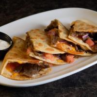 Gyro Quesadilla · Grilled piadina tortilla stuffed with gyro meat, cheddar Jack, tomato and red onion. Served ...