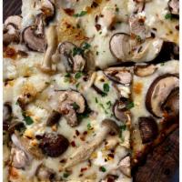 Wild Mushroom · White cream sauce, mozzarella, wild mushrooms, garlic, chili flake, goat cheese, truffle oil.