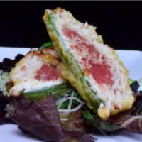 Stuffed Jalapeño  · Deep fried Jalapeño stuffed with, cream cheese, spicy tuna and crabmeat served on mix green.