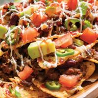 Super Nachos · Corn tortilla chips, nacho cheese, jalapenos, beans, pico, sour cream, avocado, and your cho...