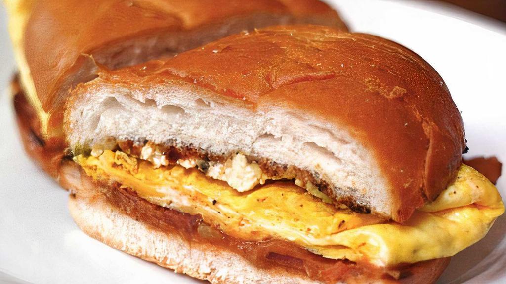 Breakfast Torta · Cheese, refried beans, scrambled eggs, and your choice of meat.