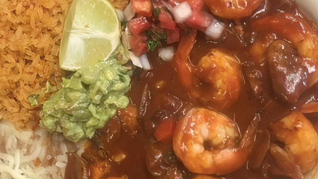 Camarones a La Diabla · Side of lettuce, pico, rice, beans, tortillas and shrimp smothered in spicy chile sauce and sauteed onions.