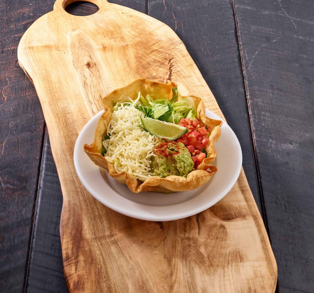Crispy Taco Salad · Fresh romaine lettuce topped with black beans, shredded cheese, salsa fresca and guacamole served in a crispy tortilla shell.