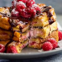 Cheesecake Brioche French Toast · 3 brioche French toast with a cheesecake topping, raspberries, chocolate drizzle and whipped...