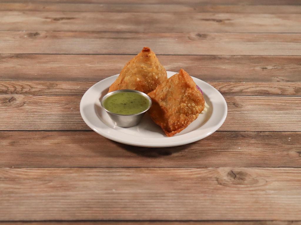 2 Pieces Vegetable Samosas · Warm crispy stuffed pastries of potatoes and green peas blended with Indian spices, perhaps the most popular stuffed pastry from the east.