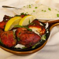 Tandoori Chicken · Chicken marinated in yogurt and freshly ground herbs and spices baked in tandoor.