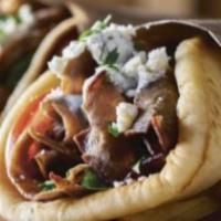 Gyro Wrap · Lamb gyro meat with tomatoes, onions and gyro sauce over rice.

