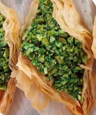 Warba with Pistachio · Layers of filo filled with pistachios and sweetened with honey syrup.

