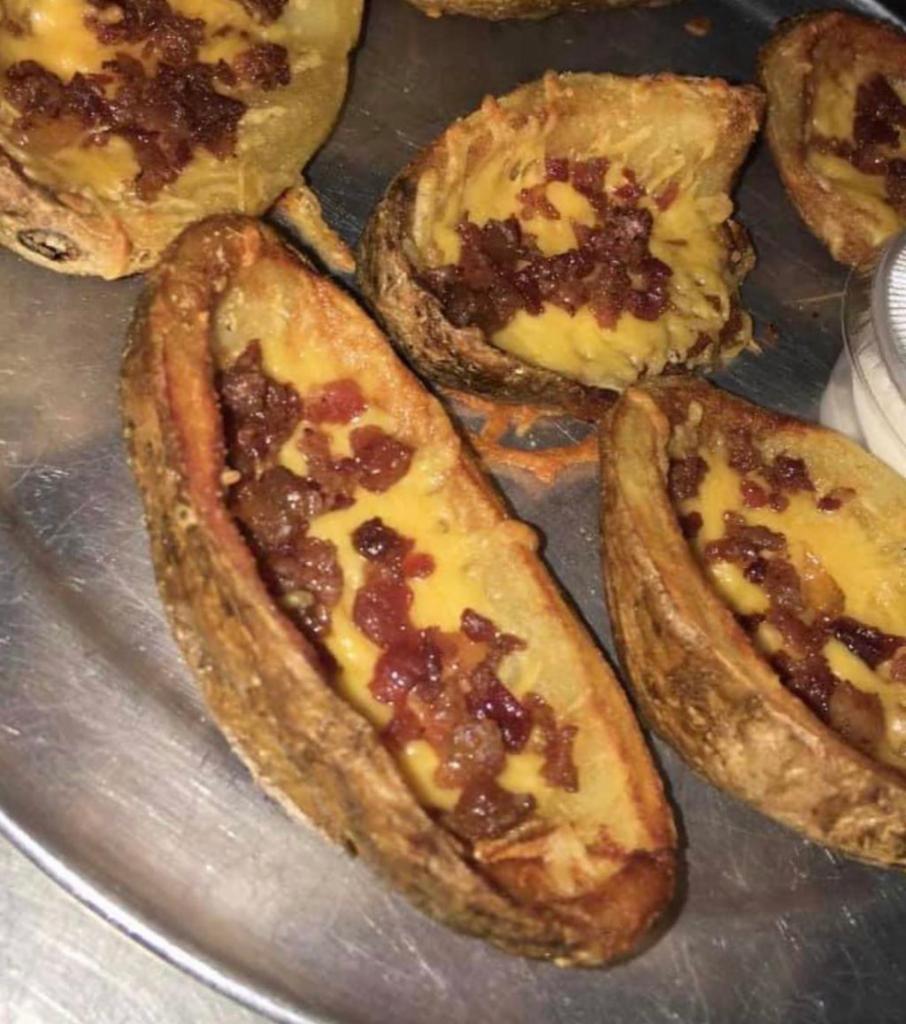 6 Potato Skins · Potato skins topped with cheddar cheese and bacon.