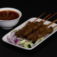 A3. Grilled Satay Beef · Skewered meat with a sauce.