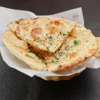 Garlic Naan · Clay oven baked bread prepared fresh seasoned garlic.