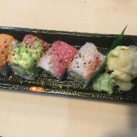 3. Rainbow Roll · Crab stick, avocado, cucumber and masago topped with tuna, salmon and white fish.