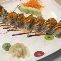 11. Spicy Citrus Roll · Shrimp tempura and cucumber wrapped in nori and topped with seared scallops, masago, scallio...
