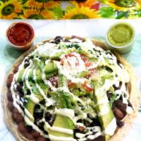 Umbrella (chicken) · Homemade corn tortilla 
Chicken, cilantro, onions, beans,lettuce ,tomatoes, Oaxaca quesillo,...