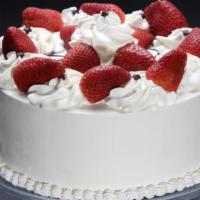 Strawberry Whip Cream Cake Slice · 3 layered white cake, filled with fresh homemade whipped cream, and sliced strawberries.