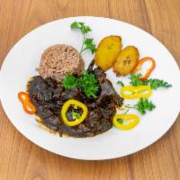 OX Tail · Served With your Choice Of Rice and Peas or white rice and 1 side of your Choice.