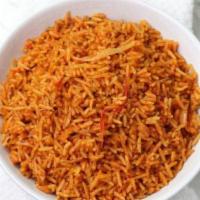 Jollof Rice · Spiced and stewed in a flavorful tomato broth, and seasoned with curry powder and dried thyme.