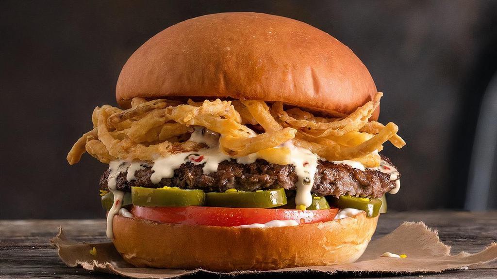 The Best Quesonario · Quarter pound of fresh, never-frozen Certified Angus Beef®, Green Chile Queso, Fried Onion Strings, Tomato, Jalapeños, Mayo, Potato Bun