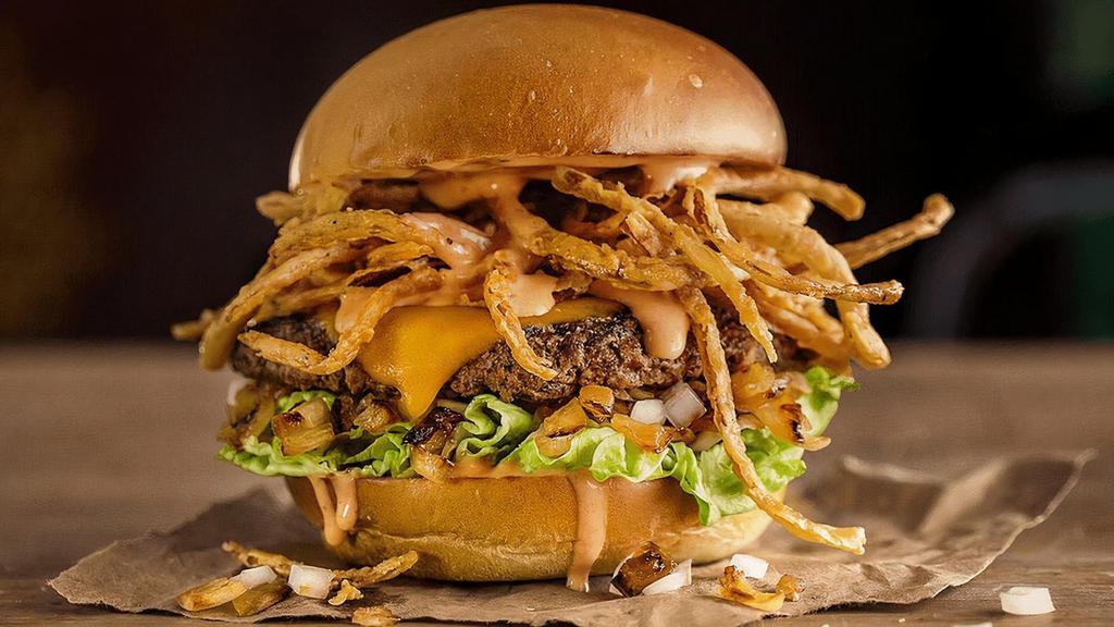 The Well D'Onion · Quarter pound of fresh, never-frozen Certified Angus Beef®, Tillamook® Cheddar Cheese, Diced Onions, Grilled Onions, Fried Onion Strings, Lettuce, Spicy Ranch, Potato Bun