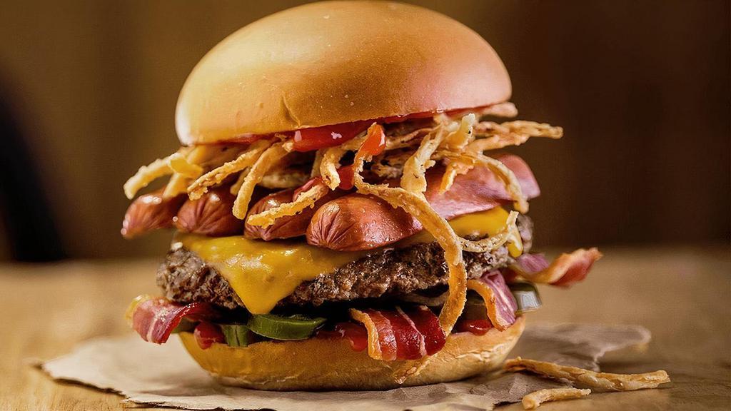 The Hamburdog · Quarter pound of fresh, never-frozen Certified Angus Beef® topped with an All-Beef Hot Dog, Tillamook® Cheddar Cheese, Bacon, Jalapeños, Fried Onion Strings, Heinz® Ketchup, Potato Bun