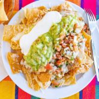 Vegetarian Nachos · Corn tortillas chips topped with refried beans, cheese, sour cream, guacamole, and pico de g...