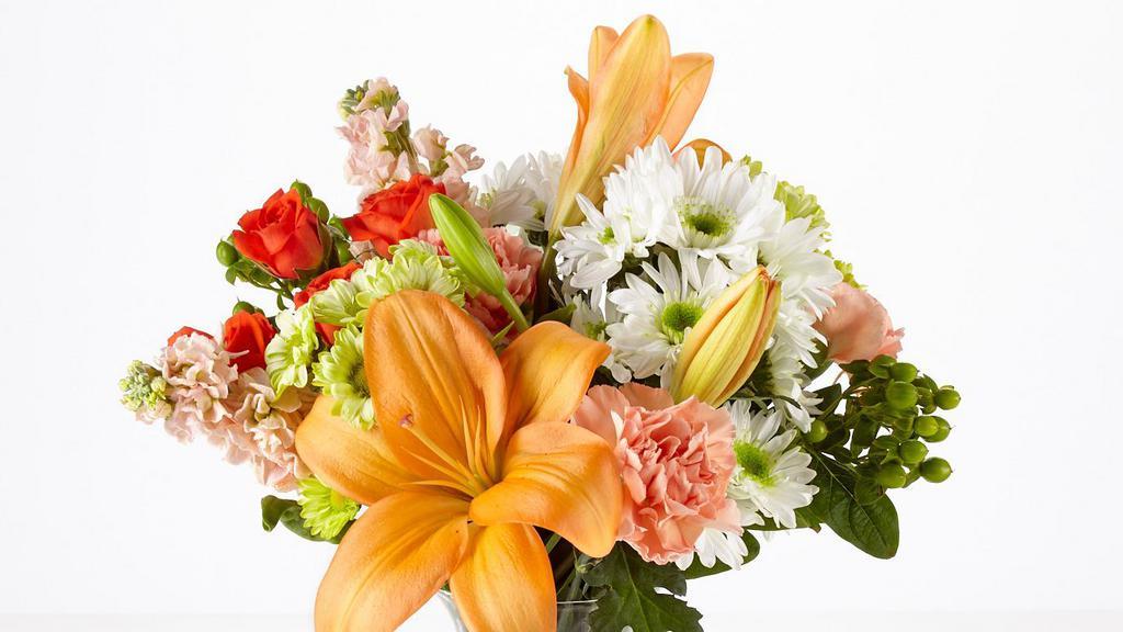 Debi Lily Perfect Gift Bouquet Arrangement · Beautiful Seasonal Bouquet arranged in a clear glass vase- Designers Choice