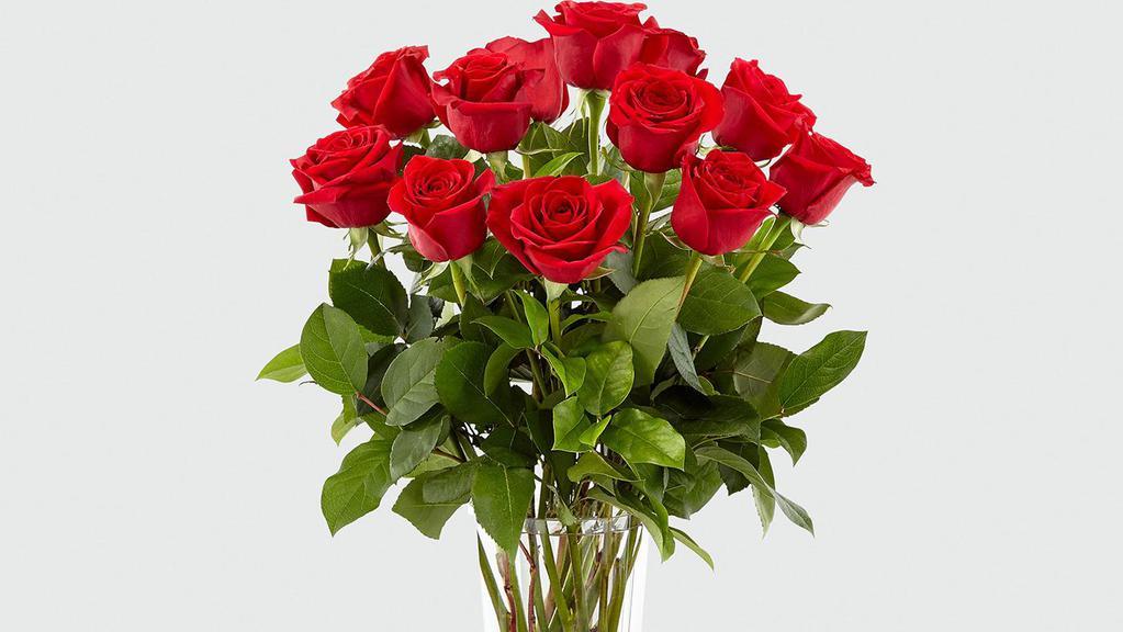 Dozen Red Rose Arrangement · 12 Long stem RED roses beautifully arranged with foliage in a clear glass vase