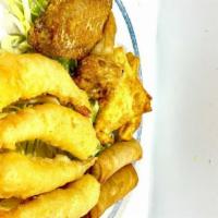B12. Combination Plate · Two egg roll, two crab puffs, two chicken wings, four fried prawns.