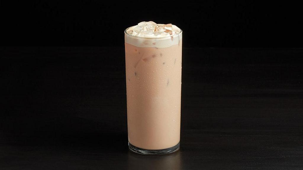 Iced Espresso Chai Latte · Sweet, spicy Masala Chai Tea is poured over ice with fresh chilled foam and milk.