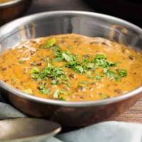 Dal Makhani (16 Oz) · Black lentil cooked with herbs and spices, then sautéed in butter and garnished with fresh c...