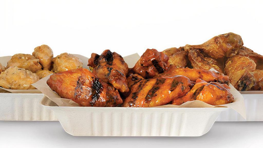 50 Wings · 50 Pit-Smoked Bone-In or traditional Boneless wings with up to 5 sauces *Dips & Veggie Sticks not Included*