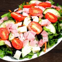Chef Salad · Romaine hearts lettuce topped with tomatoes, ham, olives, cucumbers, carrots, and a sprinkli...