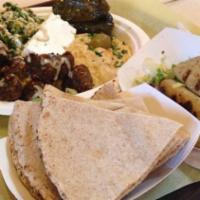 Mediterranean Plate · A combination of hummus, tabouleh, falafel, dolma, and feta cheese.