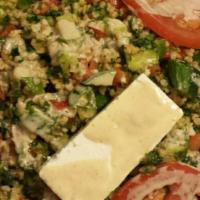 Bongo Salad · Bad of lettuce topped with tabouleh, crumbled feta cheese, tahini sauce, diced tomatoes, oni...