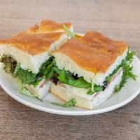Turkey Sandwich · Roasted turkey breast, provolone, tomato, greens, and mayo.
