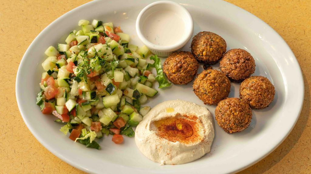 Falafel Plate · Fresh made falafel balls. Served on a plate with hummus, tahini, Israeli salad and one pita bread.