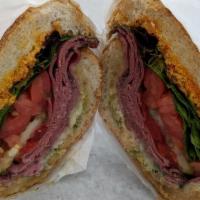 The Milanese Sandwich · Naturally smoked pastrami, organic pesto, roasted red pepper and havarti cheese.