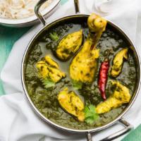 Chicken Saag Curry · Marinated boneless chicken in a fresh green spinach curry. Served with basmati rice.